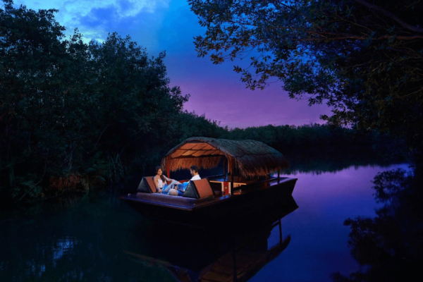 boat glides thorugh canal at mayakoba